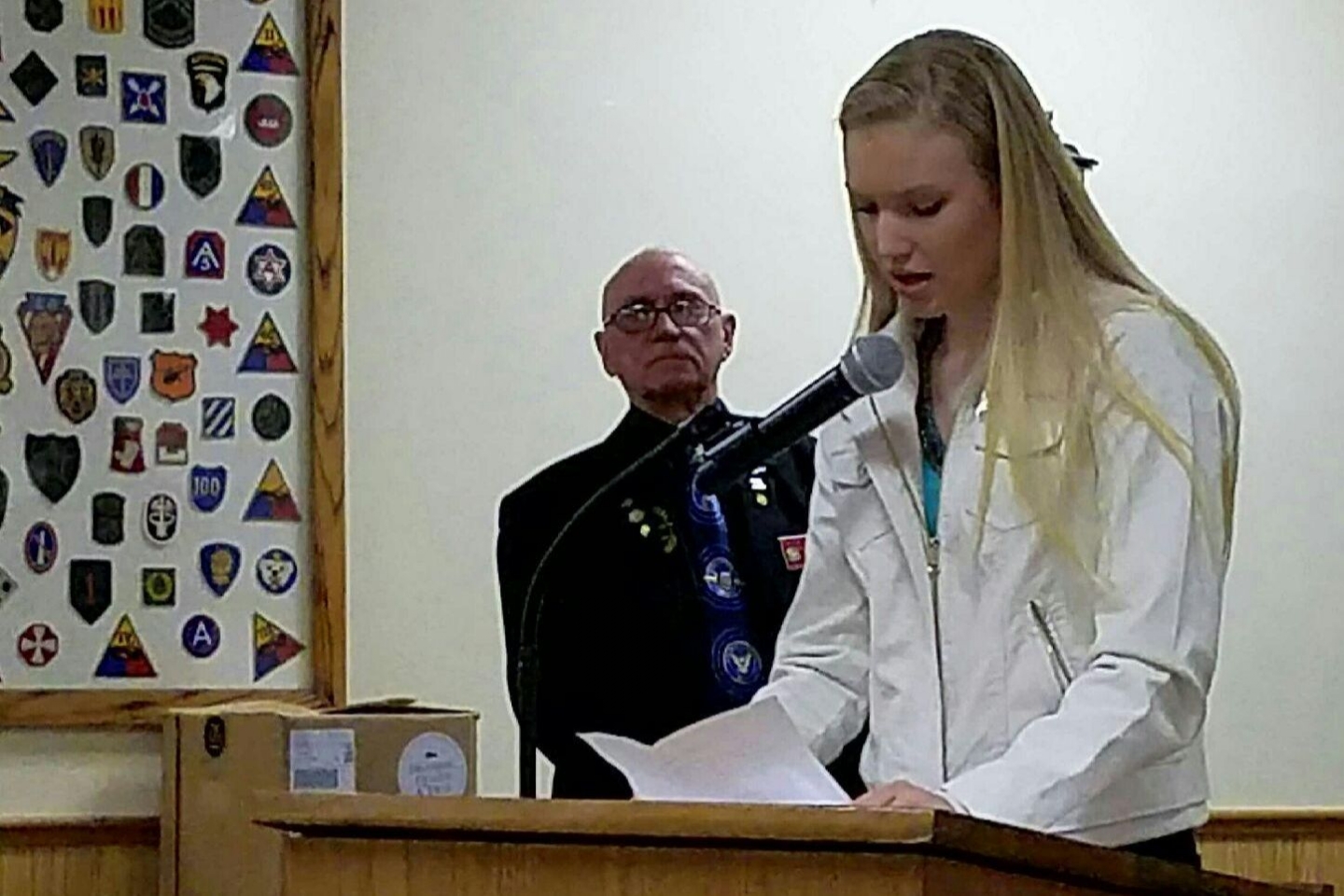 Sidney Meeks reads her winning Patriots Pen essay at Mid-Winter meeting while State Jr. Vice Commander Chuck Carroll looks on.